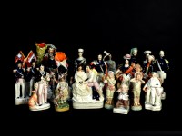 Lot 491 - A collection of thirteen Victorian and later Staffordshire flatback figures and groups to include