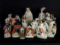 Lot 495 - A collection of Victorian and later Staffordshire flat back figures and groups to include Tam o Shanter and Sooter Johnny