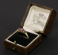 Lot 75 - A gold diamond and ruby boat shaped cluster ring
