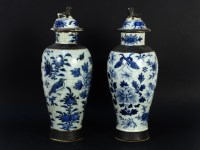 Lot 308 - A pair of 20th century oriental blue and white crackle glazed pottery vase and cover