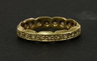 Lot 120 - An 18ct gold synthetic spinel full eternity ring