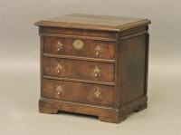 Lot 702 - A small oak chest with lift up top and two drawers