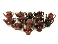 Lot 306 - Thirteen treacle glazed miniature teapots