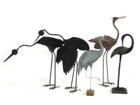 Lot 334 - A collection of four patinated wrought iron garden sculptures
