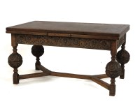 Lot 464 - A Tudor style carved oak draw leaf dining table with bulbous legs. 274cm long (open) x 91cm wide x 81cm high