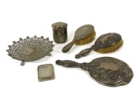 Lot 101 - A silver backed hand mirror and brush embossed with flowers
