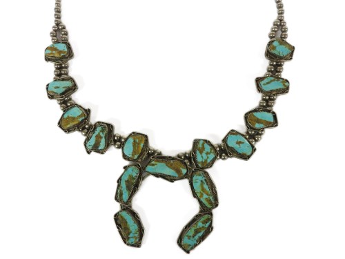 Lot 91 - A native American silver and turquoise freeform matrix tablet squash blossom necklace