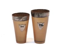 Lot 141 - A graduated pair of silver rimmed horn hunting beakers
