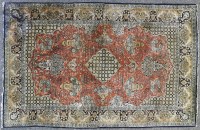 Lot 679 - A small Persian silk rug together with a modern man made fibre runner