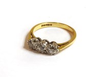 Lot 59 - An 18ct gold three stone and old European cut diamond ring