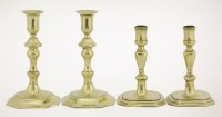 Lot 125 - Two pairs of brass candlesticks