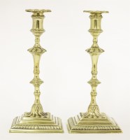Lot 128 - A pair of brass candlesticks