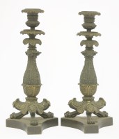 Lot 138 - A pair of Regency bronze and gilt candlesticks