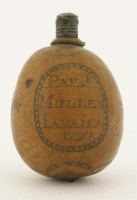 Lot 103 - An unusual engraved West Indian nut flask
