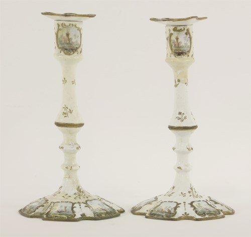 Lot 135 - A pair of Battersea enamel candlesticks