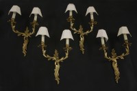 Lot 623 - A set of four twin branch gilt bronze wall lights