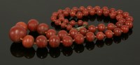 Lot 74 - A single row graduated coral bead necklace