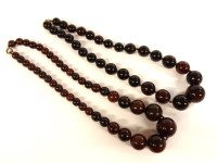Lot 62 - A single row graduated circular black cherry Bakelite bead necklace
