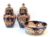 Lot 411 - A pair of Imari pattern porcelain vases and covers