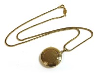 Lot 8 - A 9ct gold circular engine turned decorated locket
