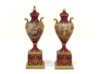 Lot 172 - A pair of early 20th century Vienna porcelain lidded twin handled urns