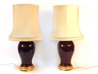Lot 421 - A pair of Sang de beouf baluster form porcelain table lamps