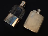 Lot 84 - Two silver flasks: one with engine turned decoration