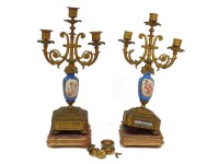 Lot 406 - A pair of late 19th century gilt metal and porcelain candelabra with three sconces on blue Celeste column and leaf decorated base