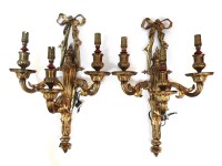 Lot 300 - A pair of early 20th century gilt metal three branch wall sconces