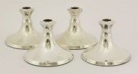 Lot 33 - A set of four George V silver candlesticks