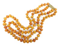 Lot 16 - A two row graduated bouton shaped amber bead necklace