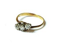 Lot 31 - A gold crossover three stone diamond ring