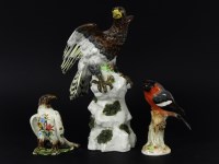 Lot 399 - Three porcelain birds: an eagle on a rocky mound