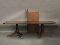 Lot 714 - A George III style mahogany twin pedestal dining table