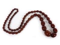 Lot 1096 - A single row graduated olive shaped ox blood Bakelite bead necklace
