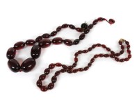 Lot 1097 - Two single row graduated barrel shaped cherry coloured Bakelite bead necklaces 
larger necklace 49.71g
Smaller necklace 15.62g
