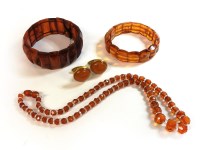 Lot 1114 - An amber panel expanding bracelet