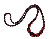Lot 1148 - A single row graduated olive shaped cherry coloured bakelite necklace