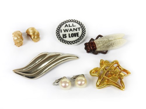 Lot 1205 - A collection of costume jewellery to include a Christian Lacroix white ceramic plaque brooch