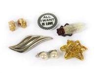 Lot 1205 - A collection of costume jewellery to include a Christian Lacroix white ceramic plaque brooch