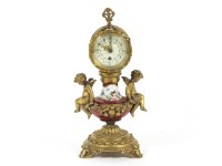 Lot 1342A - A French gilt metal and porcelain cherub mantel clock. 28cm high