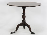 Lot 1644 - An antique mahogany tripod table