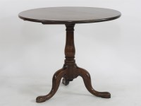 Lot 1746 - An antique mahogany tripod table