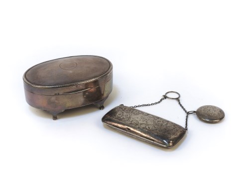 Lot 1270 - A hallmarked silver jewellery casket of oval outline with milled decoration and scroll feet