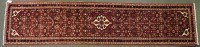 Lot 1825 - A Persian burgundy ground runner