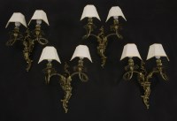 Lot 1776 - A set of four twin branch wall lights