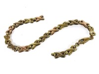 Lot 1143 - A 9ct gold cross-over link bracelet (damaged)