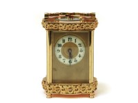 Lot 1108 - A French brass carriage clock
with fretted brass decoration
16.5cm high to top of handle