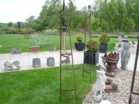 Lot 3034 - A pair of hand forged wrought iron triangular garden obelisks