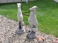 Lot 3038 - A pair of cast stone garden sculptures of whippets